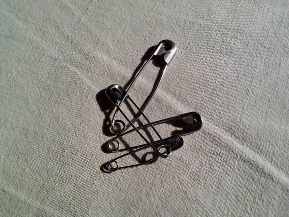 safety pins, metal, textile, bedding, sheets