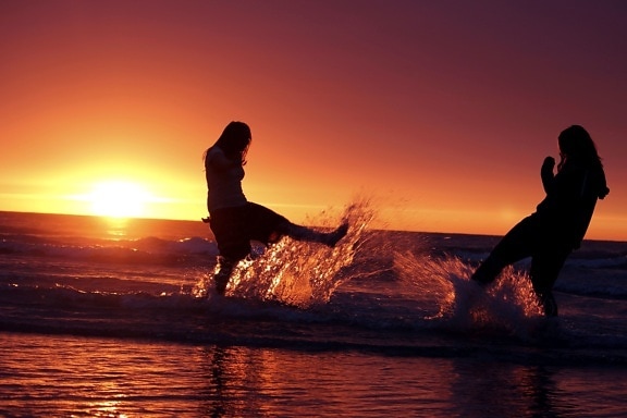 two girls, sunset, water