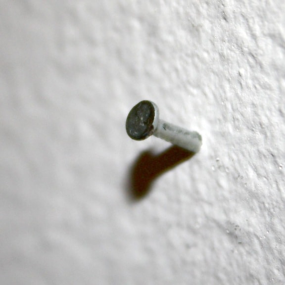 small nail, sticking out, wall