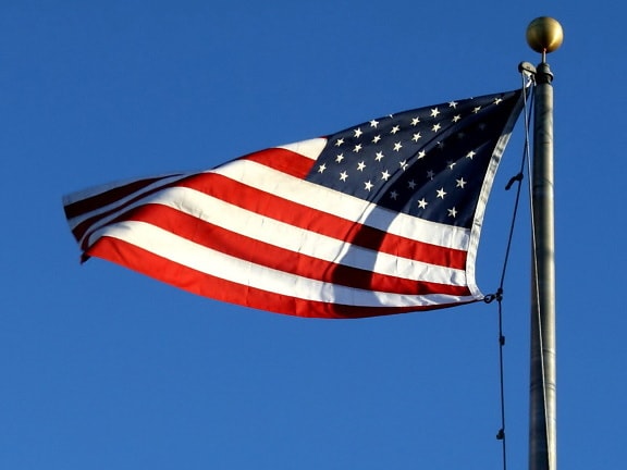 American flag, wind, blue sky