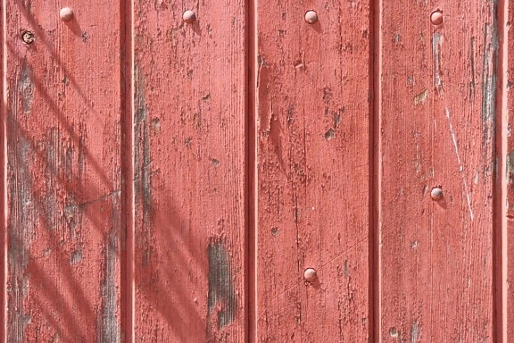 old wood fence, peeling red paint, wooden planks, texture