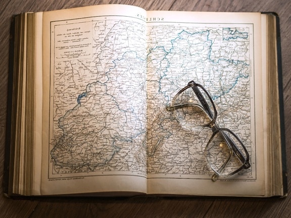map, paper, table, wood, book, eyeglasses, information