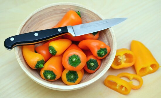 bell pepper, bowl, knife, table, salad