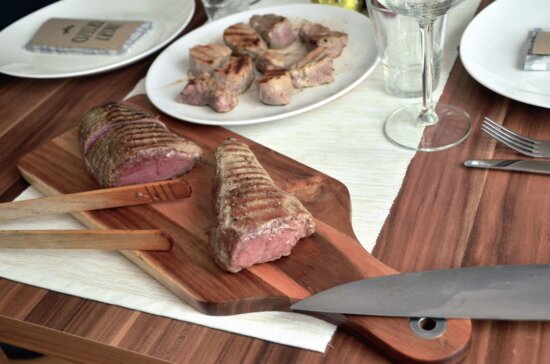 meat, cutting board, knife, food, glass, fork, plate