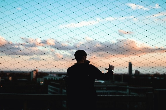 man, fence, sunset, city, silhouette