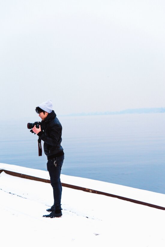 man, photographer, photo camera, snow, winter, hat, glasses, river, water