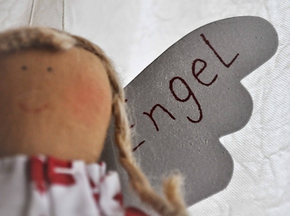 toy, angel, doll, object, material, text