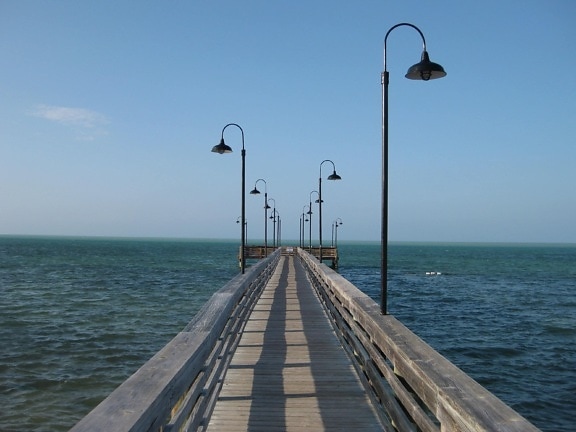 sky, pier, sea, street lamp, daylight, ocean, seashore, water, boat, outdoor