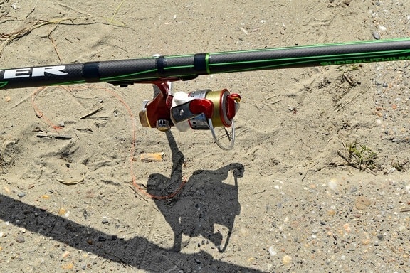 fishing gear, fishing rod, nylon, soil, sand, ground, road, outdoors