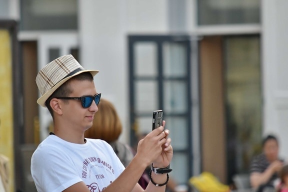 cellphone, handsome, hat, man, photographer, side view, street, people, portrait, daylight