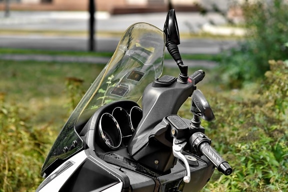 mirror, motorcycle, park, parked, parking lot, urban area, windshield, outdoors, grass, vehicle