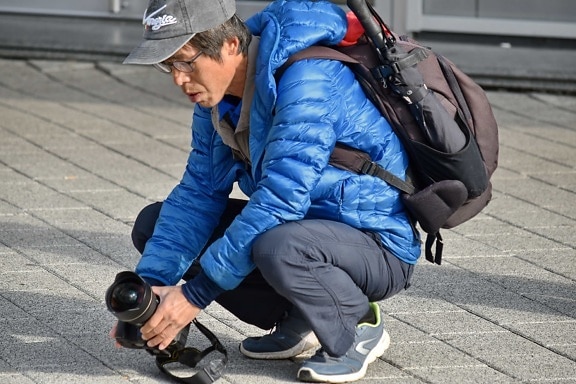 angle, camera, equipment, eyeglasses, hands, lens, pavement, perspective, photographer, photojournalist
