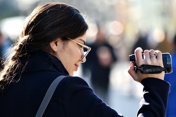 businesswoman, camcorder, confident, move, photojournalist, side view, smile, woman, street, girl
