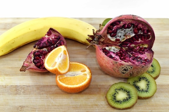 antioxidant, banana, kitchen table, kiwi, mandarin, pomegranate, ripe fruit, slices, vitamin C, produce