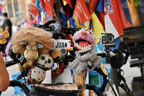 bicycle, camera, colorful, stuffed, toys, travel, covering, mask, festival, street