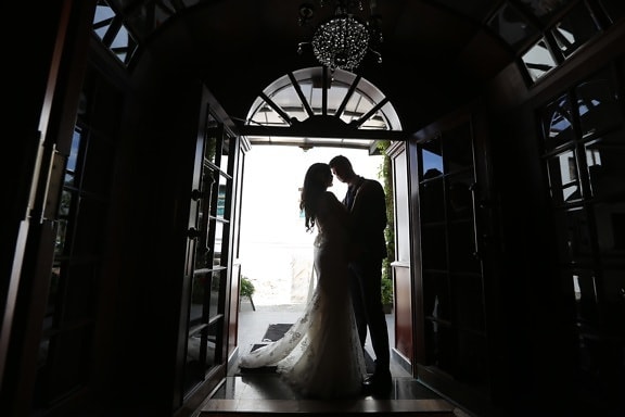 bride, chandelier, entrance, front door, gate, groom, kiss, silhouette, dress, wedding