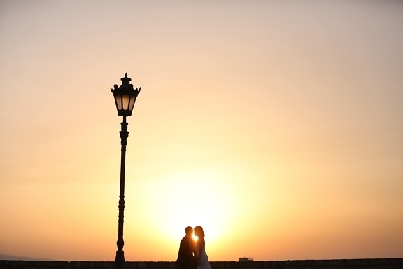 kiss, lamp, man, pretty girl, romantic, street, suit, sunset, wedding dress, silhouette