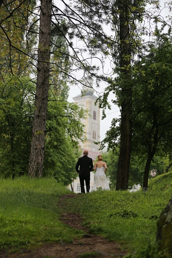 husband, wife, walking, man, woman, forest trail, wedding, wedding dress, fashion, church tower