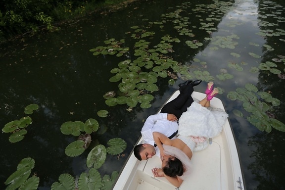 groom, bride, lily pad, boat, canal, river, water, aquatic, pool, child