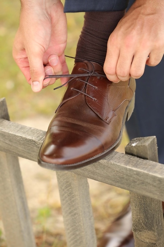 shoelace, light brown, shoe, sock, hands, picket fence, businessman, footwear, hand, foot