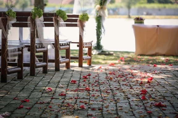 wedding venue, outdoors, floor, wedding, flowers, petals, bench, furniture, garden, architecture
