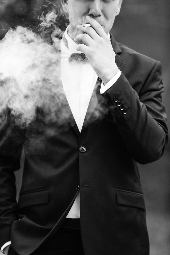 cigarette smoking, smoke, tuxedo suit, clothing, business, garment, suit, person, man, businessman
