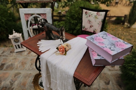 sewing machine, books, clothes, vintage, outdoors, wood, table, old, flower, furniture