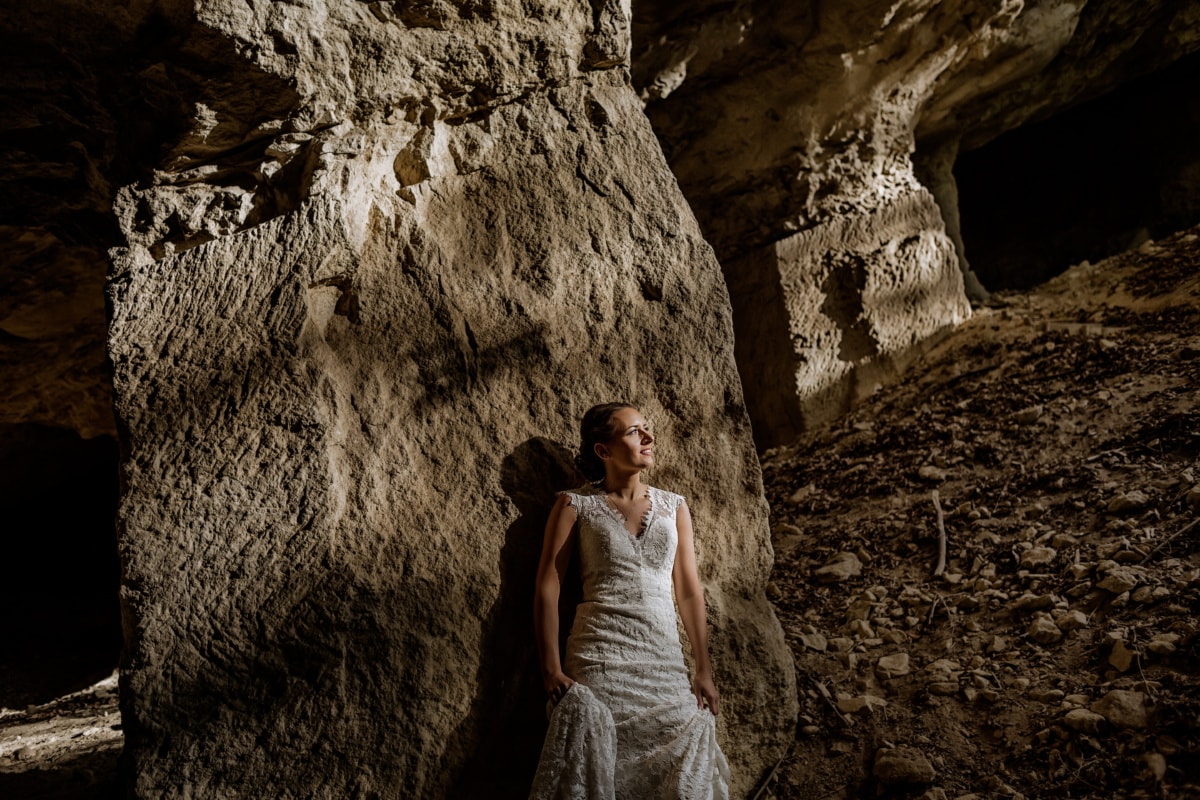 smiling, young woman, underground, cave, dress, fashion, sunlight, sunrays, girl, woman