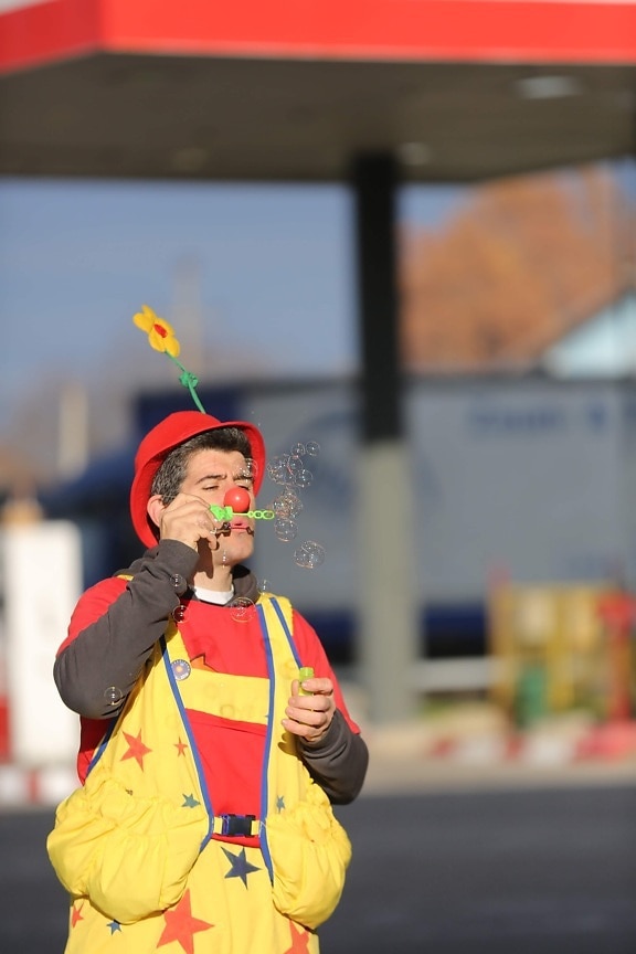blowing, clown, bauble, entertainer, person, performer, street, people, outdoors, festival