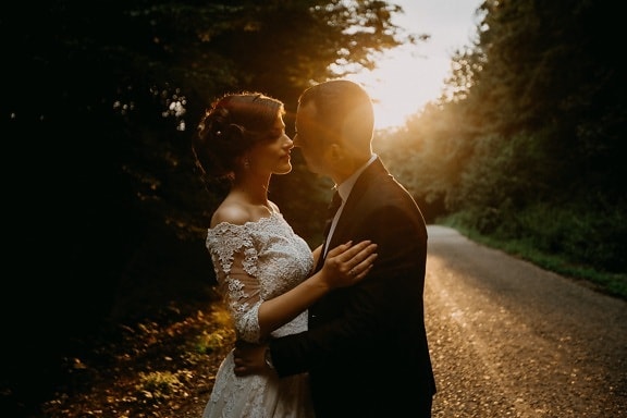 bride, kiss, groom, forest road, sunset, marriage, embrace, hugging, love, wedding