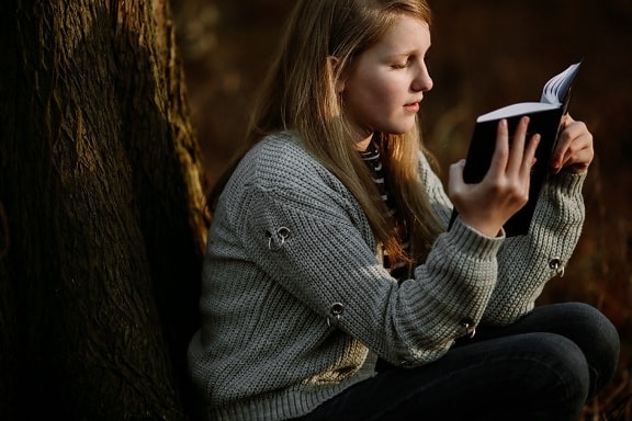 young woman, student, reading, book, tree, outdoor, outfit, sweater, knitwear, cardigan