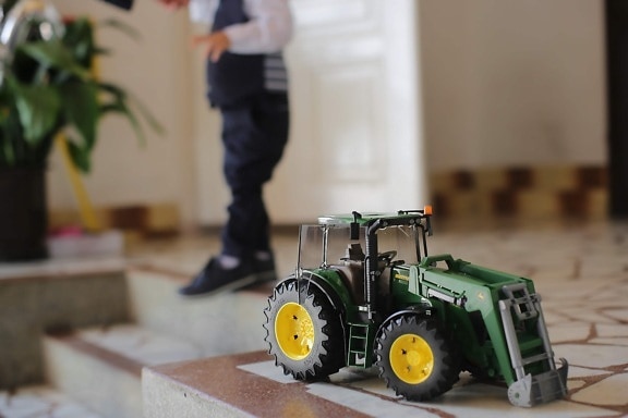toy, vehicle, tractor, toddler, boy, indoors, machinery, blur, child, machine
