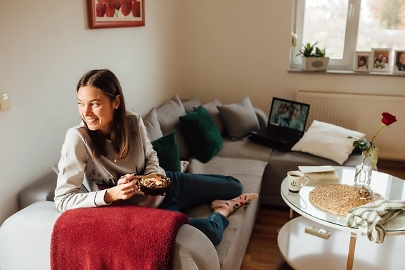 young woman, smiling, breakfast, living room, relaxation, sofa, lifestyle, laptop computer, room, indoors