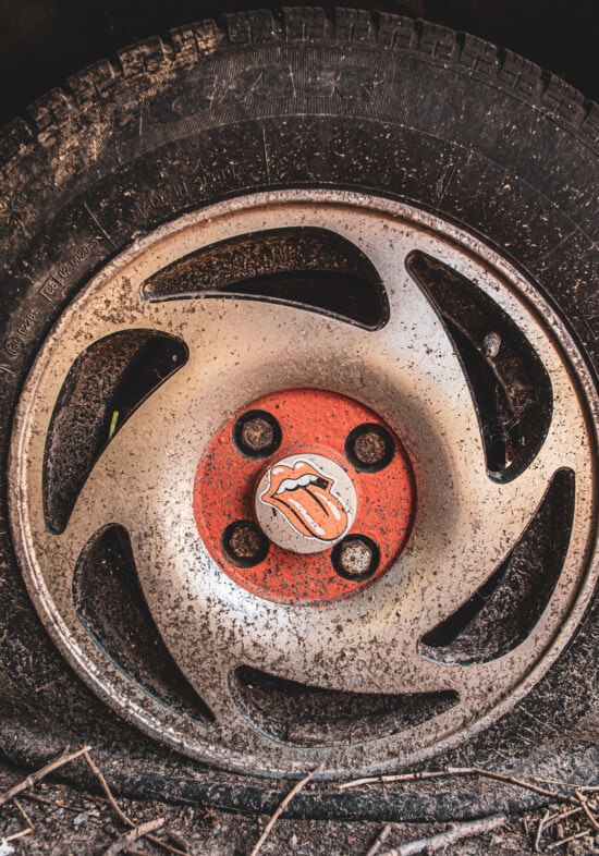 Rolling Stones sign, rim, old style, tire, nostalgia, decay, trash, dirty, old, car