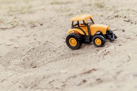 plastic, toy, tractor, sand, vehicle, ground, outdoors, yellow, dirt, bright