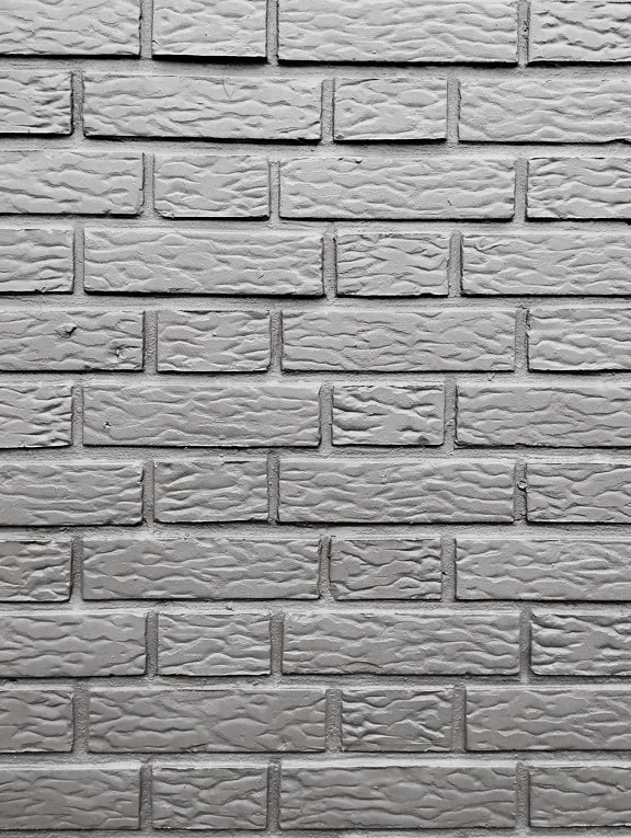 Wall with white bricks with cement mortar illustrating horizontal masonry, black and white photo