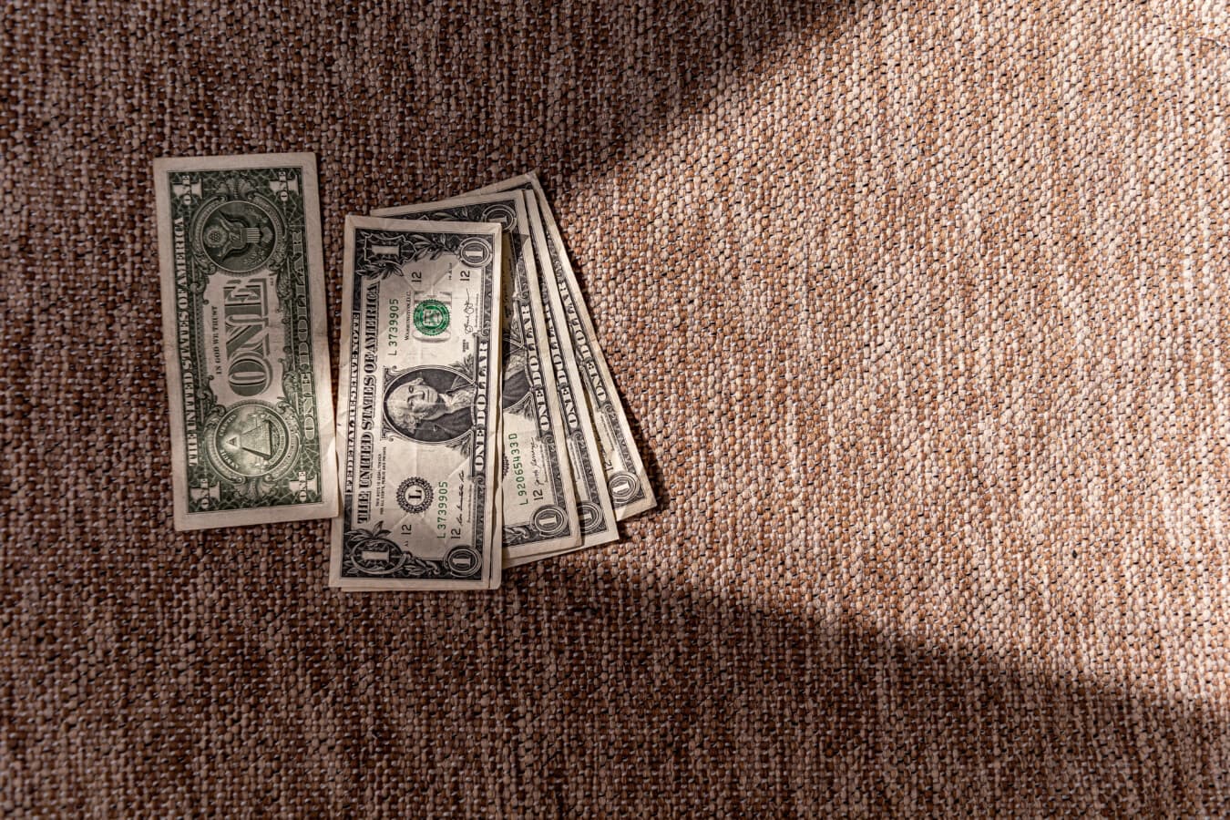 (1$) One dollar bill in shadow with light on pyramid