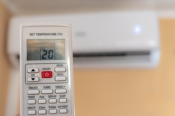 Air conditioner remote control with room temperature at twenty degrees of Celsius (20° C)