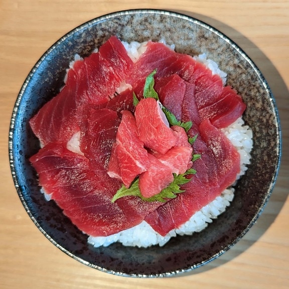 Raw uncooked sushi meat with rice in plate – Tekka Don