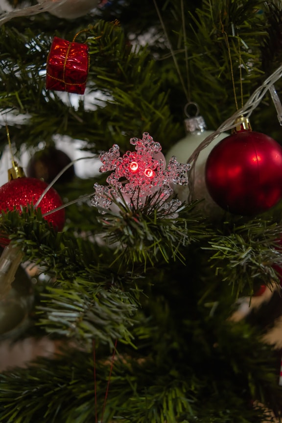 Glowing snowflake decoration on Christmas tree