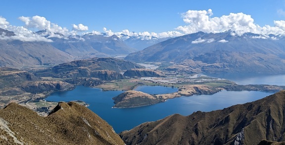 Panorama of calm lakes with mountain peaks in New Zealand