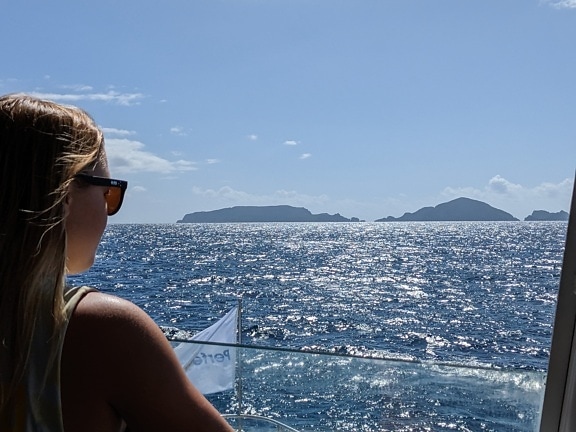 Young blonde woman on enjoys view of horizon