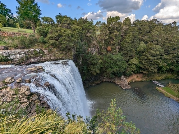 Beautiful Whangarei waterfall splashing into lake landscape
