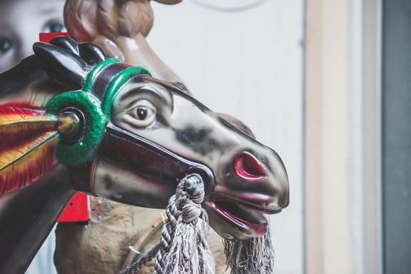 Close-up of vintage carnival carousel with horse head