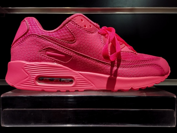 Fancy pink sneaker on shelf in store