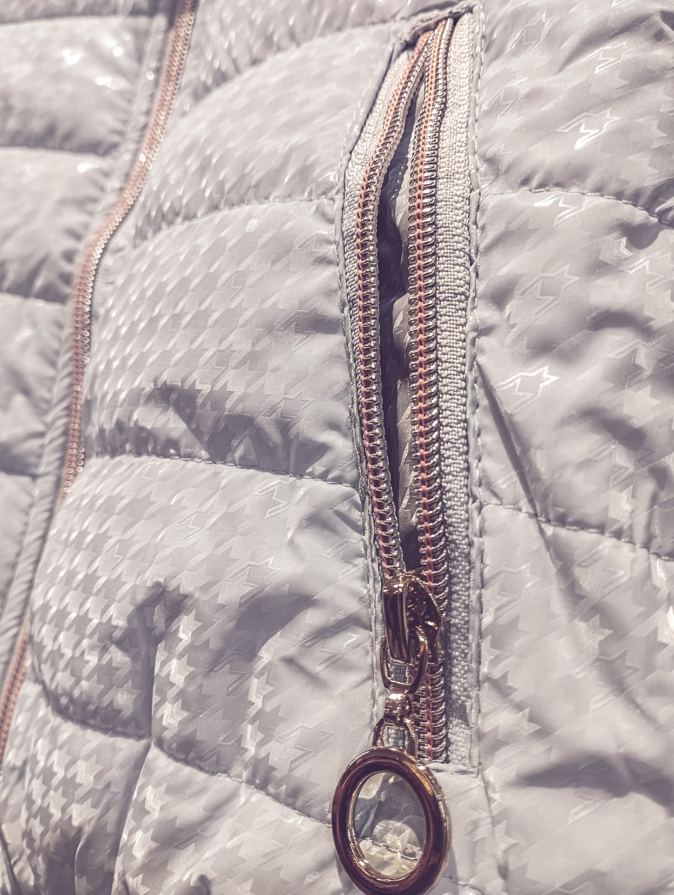 Close-up of pocket zipper on grey fancy jacket