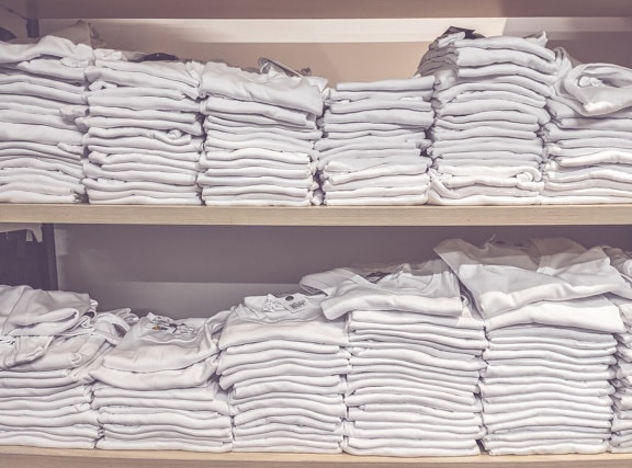 White sweatshirts on shelf in store