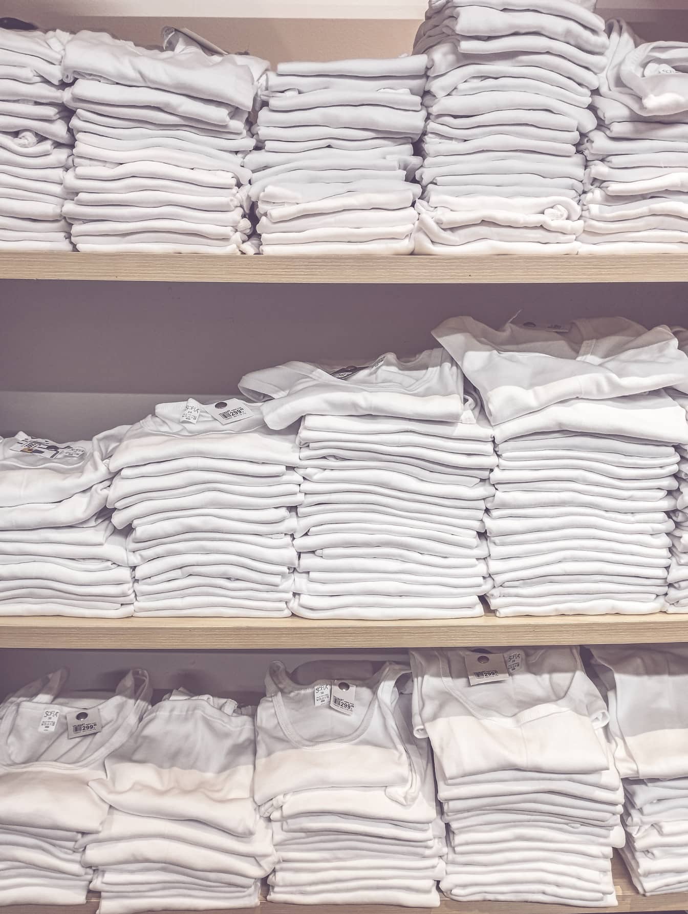 Pure white cotton sweatshirts on shelf in store