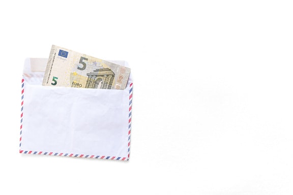 Five (5€) Euro banknote in white envelope