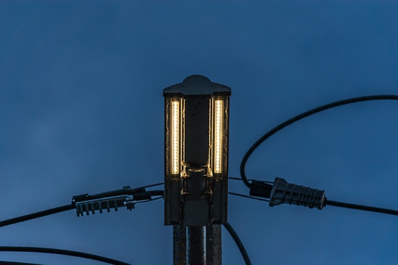 Led light bulb on electric pole close-up wires